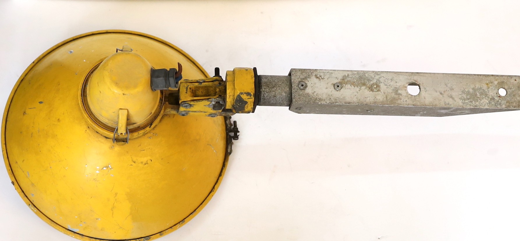 A 1950s yellow enamelled and aluminium floodlight, height 70cm. diameter 34cm
